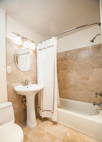 Newly renovated bathroom with tiled floors and walls - 3719 12th St NE