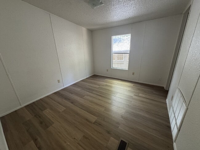 Building Photo - 3 bed 2 bath on one acre lot. New vinyl flooring throughout.