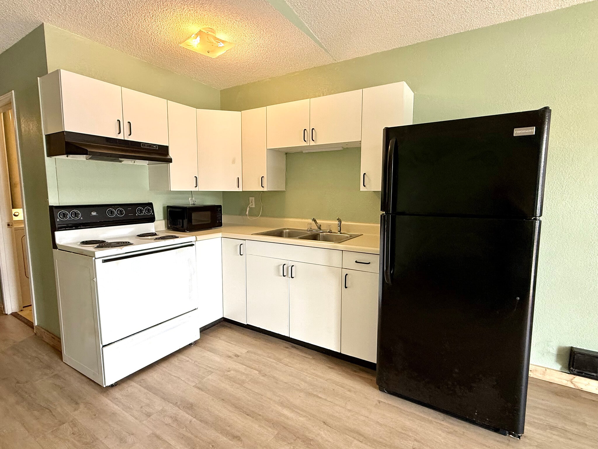 Modern kitchen with fridge, mw, and range - 377 AR 56 Hwy