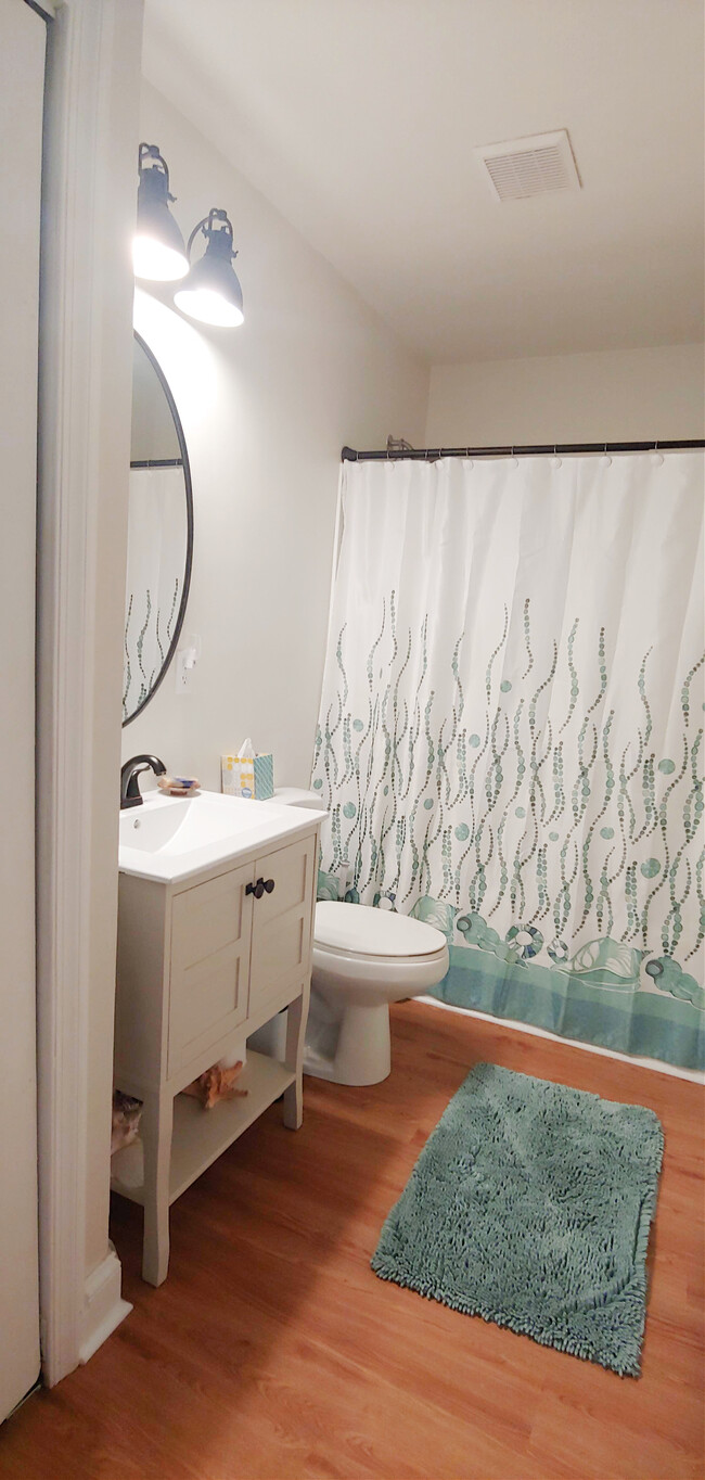 Bathroom with full tub and additional built in storage in a wall niche by the sink - 819 Page St