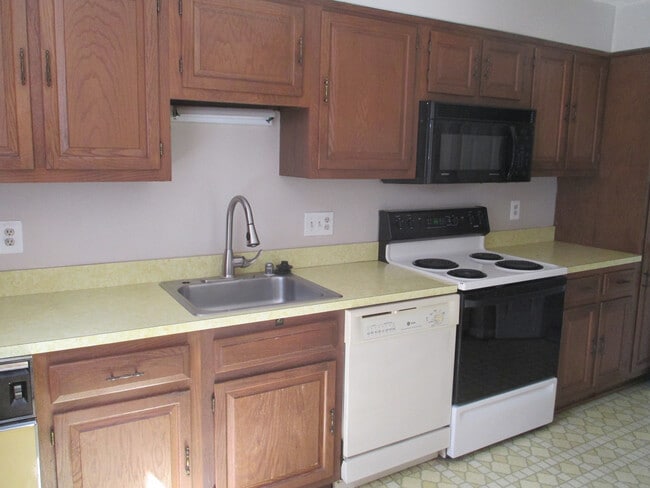 Building Photo - SPACIOUS BRICK TOWN-HOME