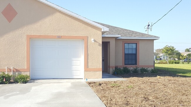 Building Photo - NEWER 3 bedroom 2 bath 1 car garage duplex in SW Cape!!  Lawn Care Included~