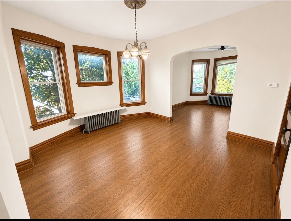 AI representation of existing living and dining rooms. Radiators will be removed - 2256 Lawndale Ave