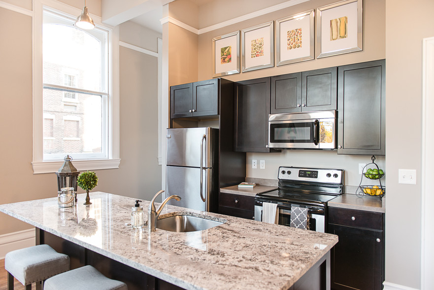 Typical Kitchen with Granite Counter Kitchen Island, Breakfast Bar, & Stainless Steel Appliances - 300 Alexander Apartments