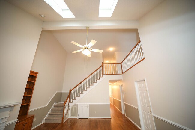 Living room looking up at loft/2nd bedroom +bath - 109 Pelham Dr