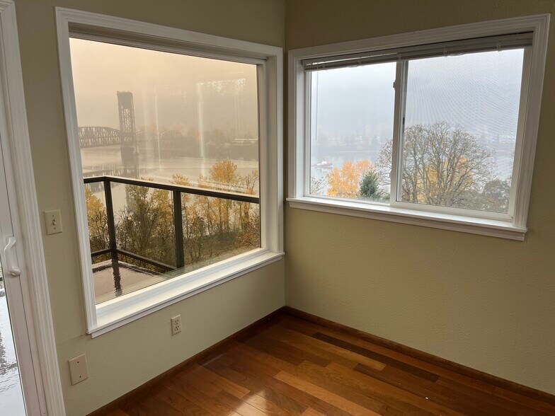 SW corner of living room showing view over Willamette River and Forest Park - 7511 N Edgewater Ave