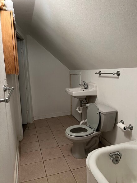 Bathroom with a bathtub on the left and a shower on the right corner - 2432 Prais St