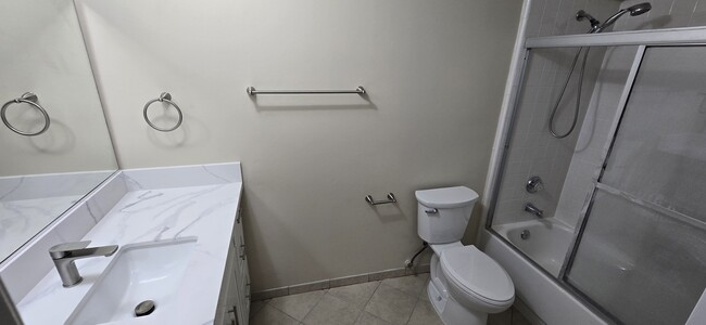Bathroom has new toilet and new TP holder and towel ring/rods. Bathtub includes glass shower door - 14365 Foothill Blvd