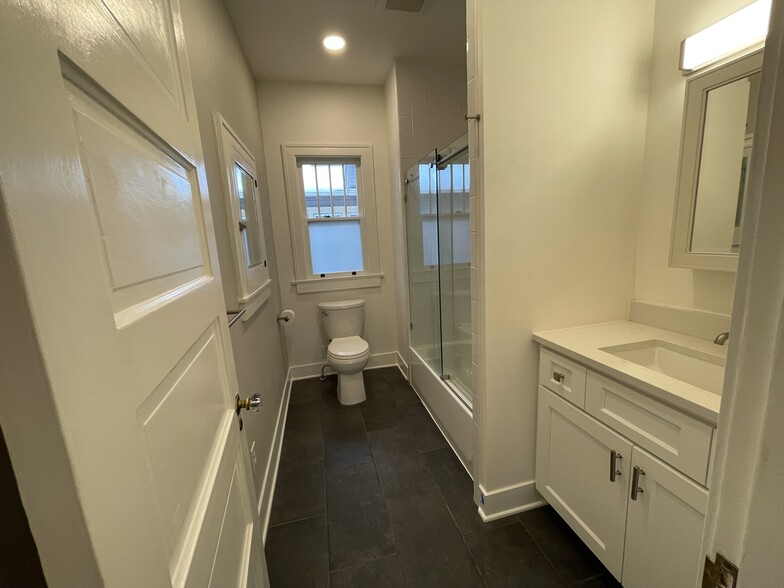 Main floor bathroom is tiled and has glass shower enclosure - 508 Daly Ave