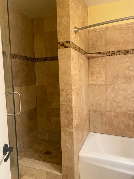 Main Bathroom with 2 showers and a bath - 8710 Delgany Ave