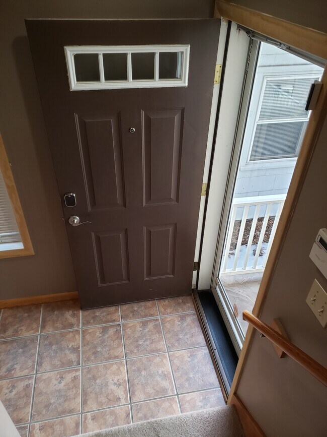 Front door stairwell, forward is stairwell to garage, Immediate left up to Main Floor - 4523 State Line Rd