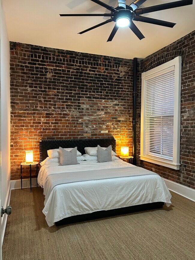 King bed with 4 built in dresser drawers for clothing and storage. - 20 W Oglethorpe Ave