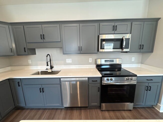 Building Photo - “Stylish 3BR End-Unit | Open Concept | Quartz Kitchen | Garage + Deck