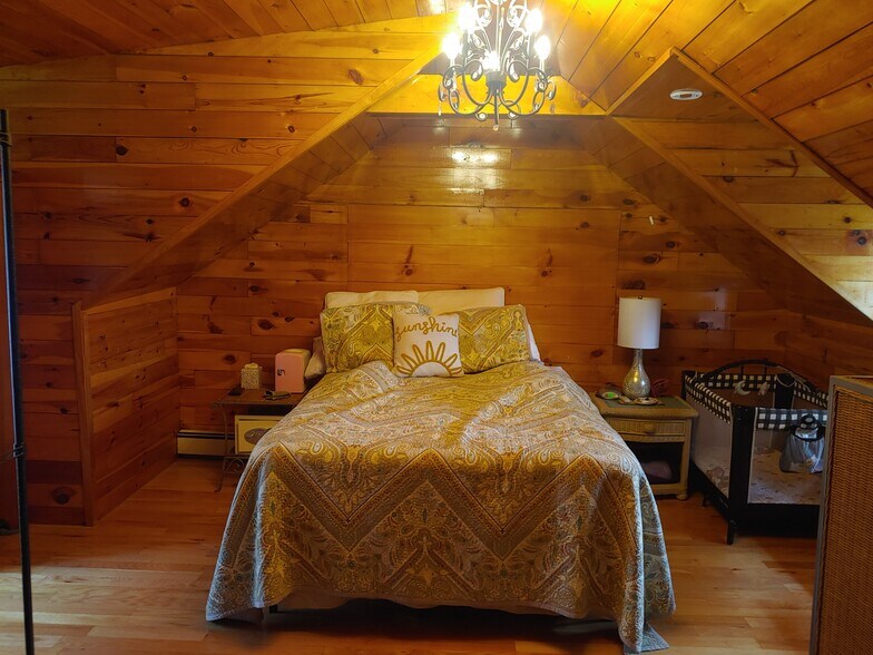 All pine walls in bedroom - large picture window and 2nd window , some storage - 623 Old West Central St