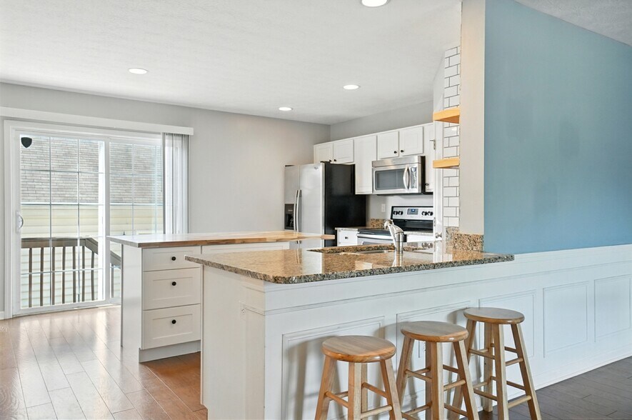 Kitchen with granite countertops and stainless steel appliances - 6169 Needletail Rd