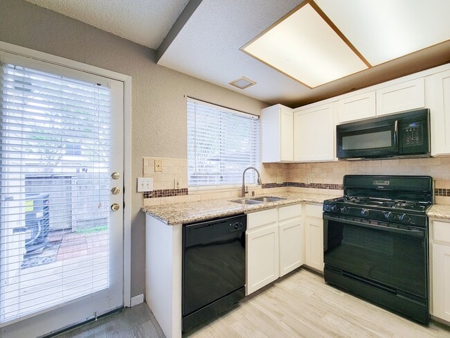 Building Photo - Welcome to This Charming Townhome Nestled ...