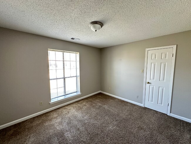 Building Photo - Grand 4BR/2BA Near Southwind | 2,438 Sq Ft, Stone Fireplace, Soaking Tub & 2-Car Garage