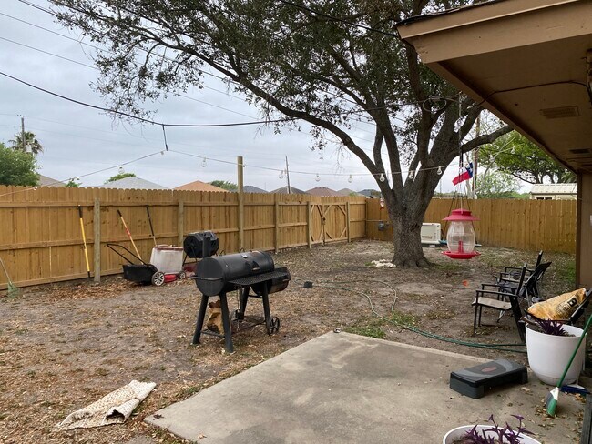 Fenced backyard with gates on each side to access alleyway. - 6725 Meadowbreeze Pky