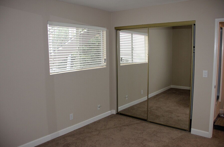 2nd bedroom_mirror closet door_palm tree visible - 227 La Paloma