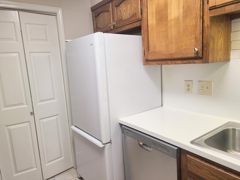 Large refrigerator with ice maker next to the laundry room - 12439 Coursey Blvd