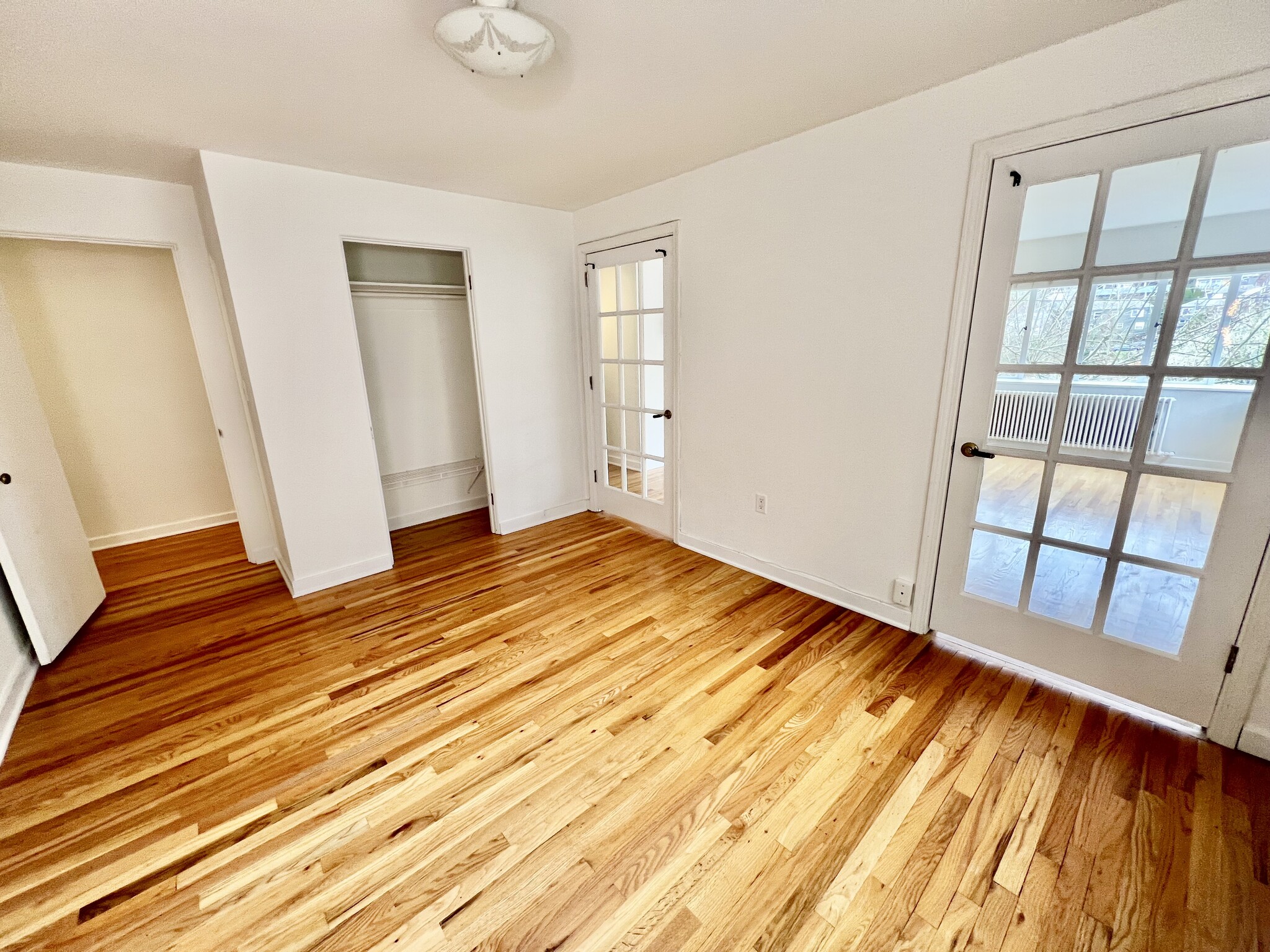 Main bedroom with French doors to LR, closet, hallway door. - 1800 Taylor Ave N