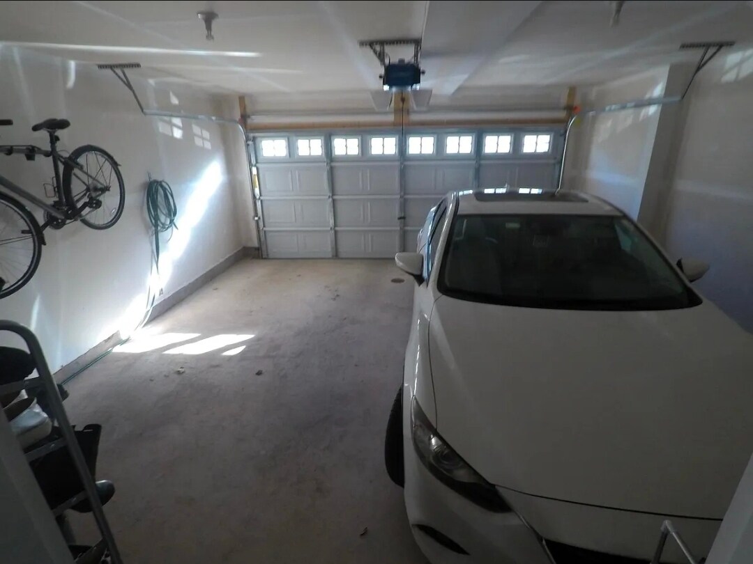 Spacious 2-car garage, elevated bike rack, storage nook (not visible) - 8828 Englewood Farms Dr