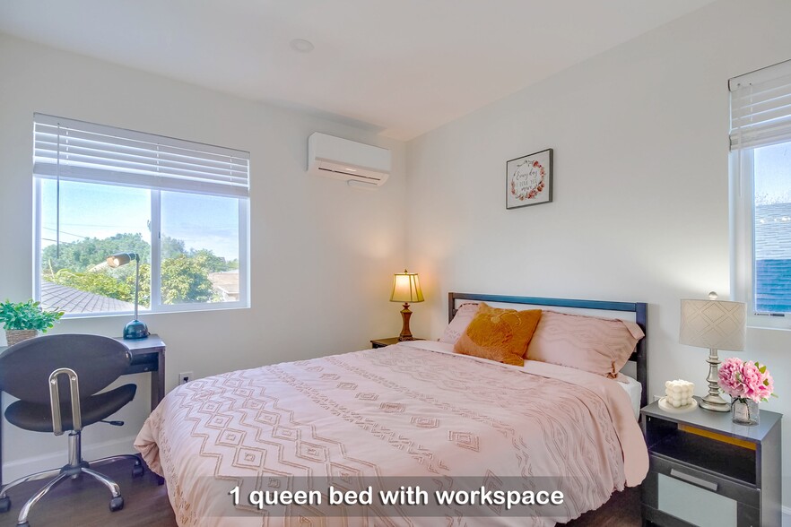 Experience abundant natural light in Bedroom 2, where you can unwind in a cozy queen bed - 723 E 22nd St