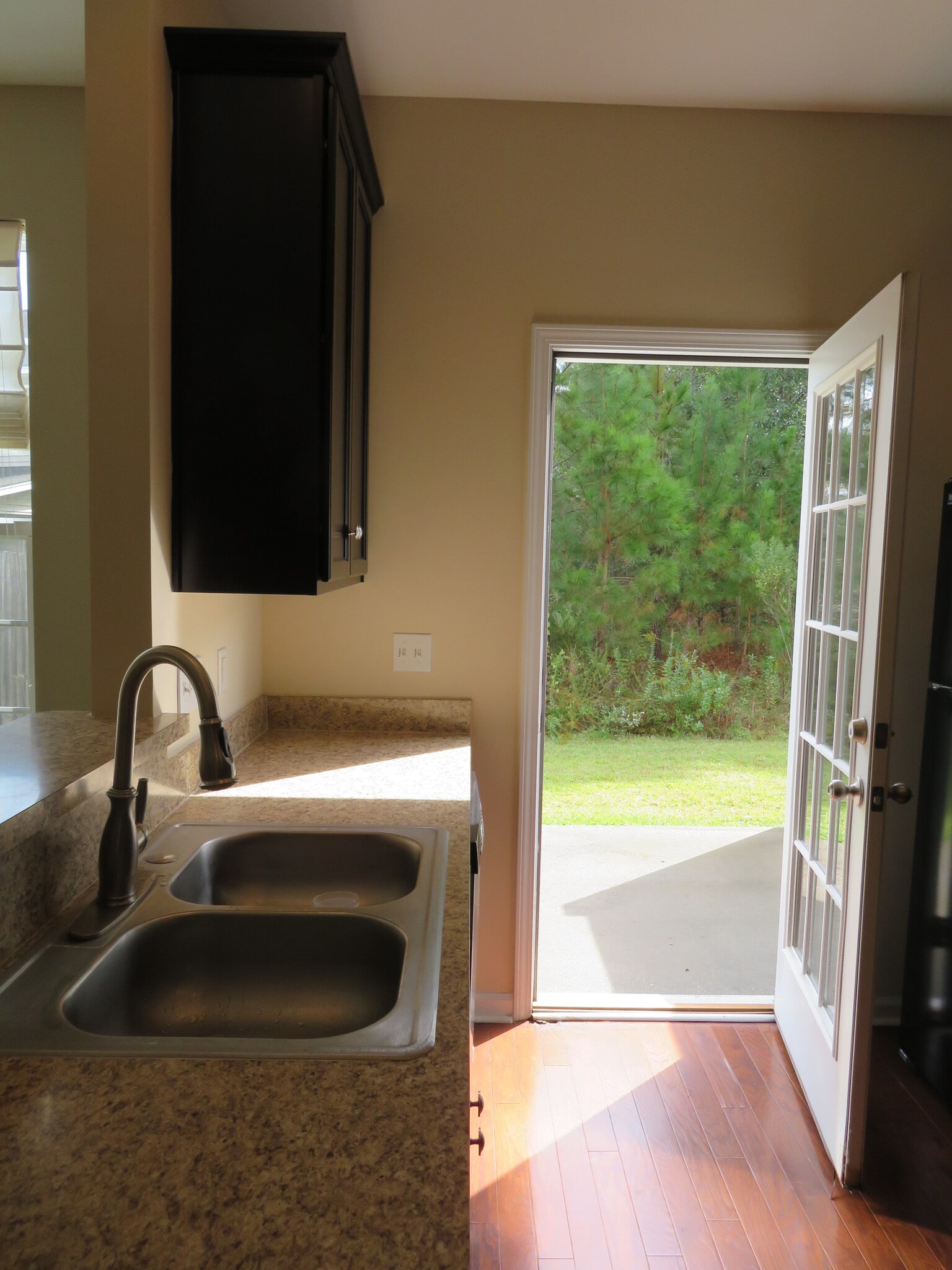Kitchen French door opens to concrete patio and backyard, which backs onto Community Preserve - 2496 Stadium Dr