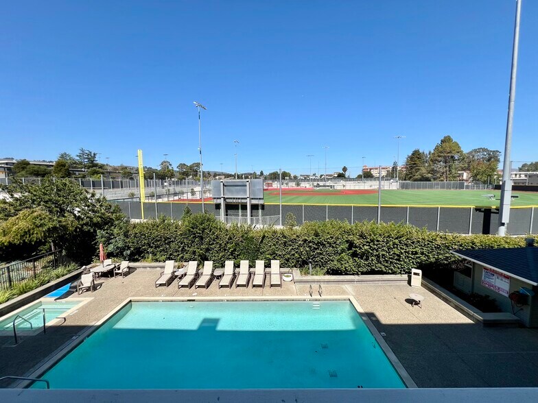 View from balcony: pool, hot tub, field - 300 Murchison Dr, #202