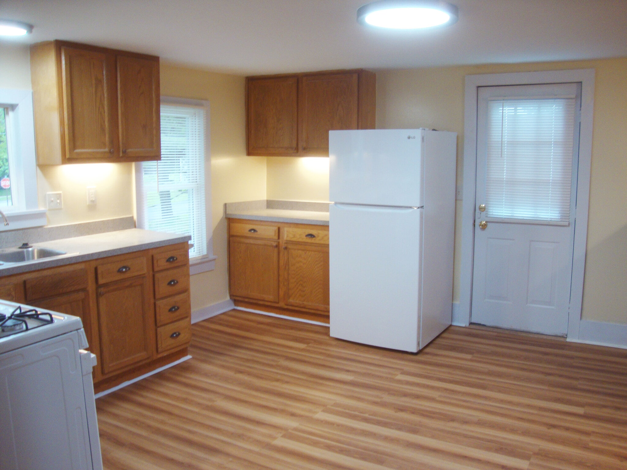 Kitchen with refrigerator next to entry door. - 351 W Currant St