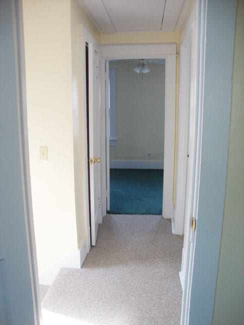 Hall toward front bedroom. Stairs on left. Bathroom on right. - 458 McConnell St
