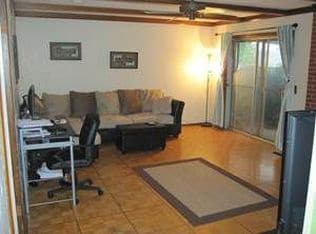 living room with patio door, gas fireplace and wood floors - 4401 Northwest 55th Street