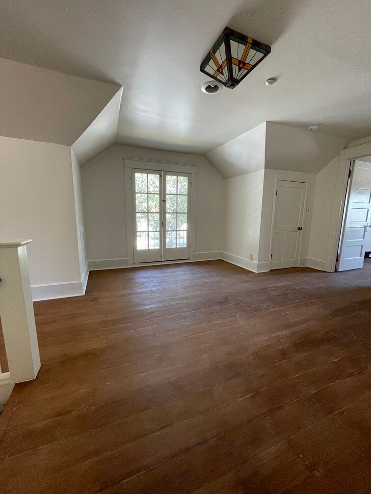 Large den area between two bedrooms and a separate porch with sitting area. - 1135 Magnolia St