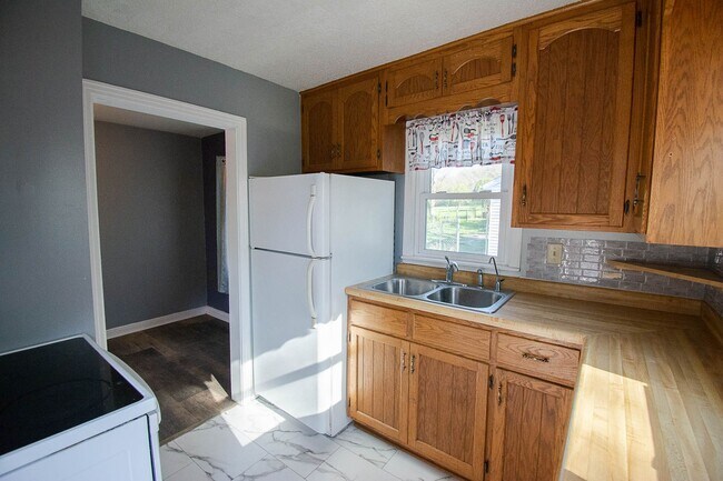Building Photo - Fenced Yard, 2-Car Garage + Quiet Location!