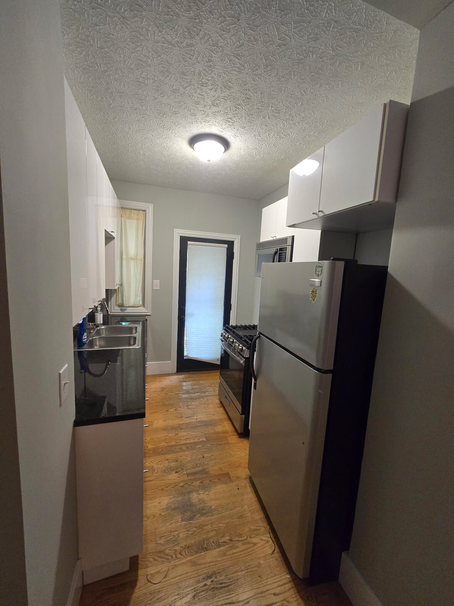Kitchen. Microwave, gas stove, large fridge, easy to clean cabinets - 1218 S Washington Ave