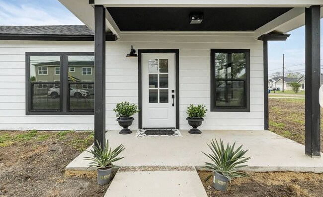 The front door now has a fingerprint scanner and digital access code. - 5401 Burton Ln