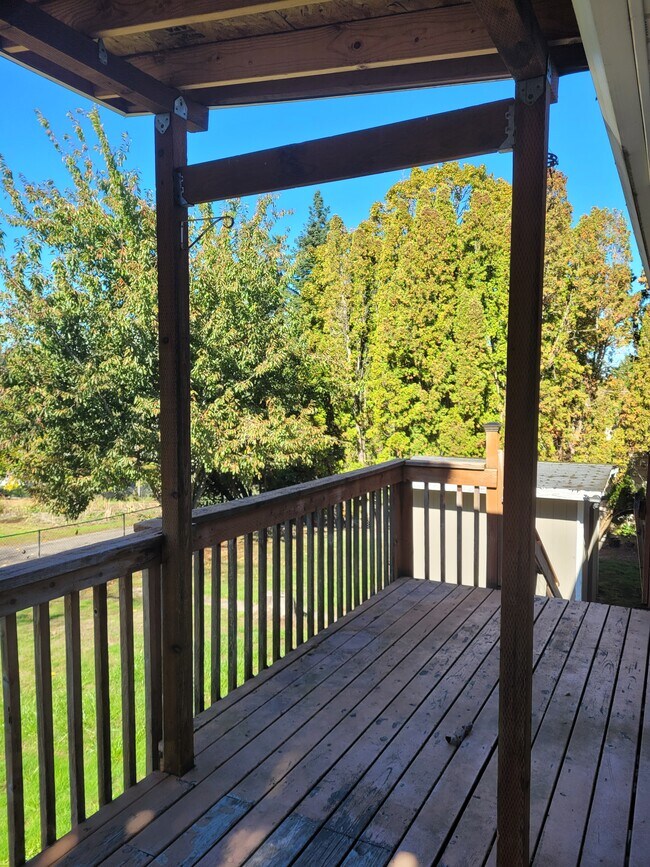 back yard deck has stairs down to the yard, shed and garage - 5095 SW 163rd Ave