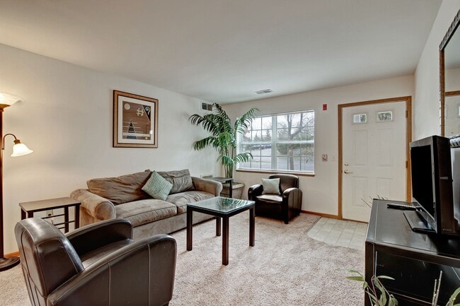 Arbor Ridge Living Room View with Couches, Television, and Window - Arbor Ridge
