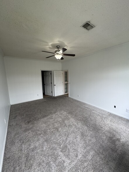 Master bedroom with entrance to bathroom on the left and doorway leading to living area and kitchen. - 1701 Water Oak Dr