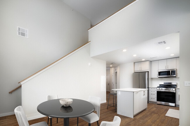 Loft apartment with stainless steel appliances, white quartz countertops, light grey cabinetry, and hard surface flooring - Kanso Milford