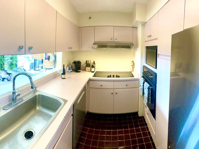 Galley kitchen with open pass through to living/entertainment area. New Bosch dishwasher and fridge - 1221 Victoria St