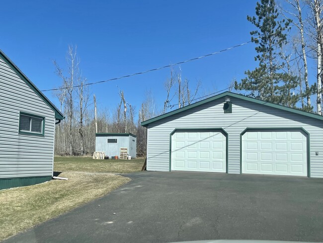 View of side of home, small shed w/ converted chicken coop (not shown here), 2 car grg w/ Workshop - 8231 E Superior St