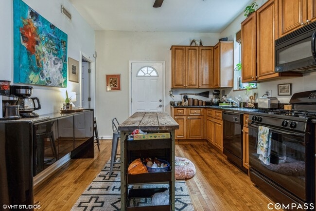 Kitchen with dishwasher, gas stove, sink disposal, and French door fridge. In unit laundry. - 1227 N Rockwell St