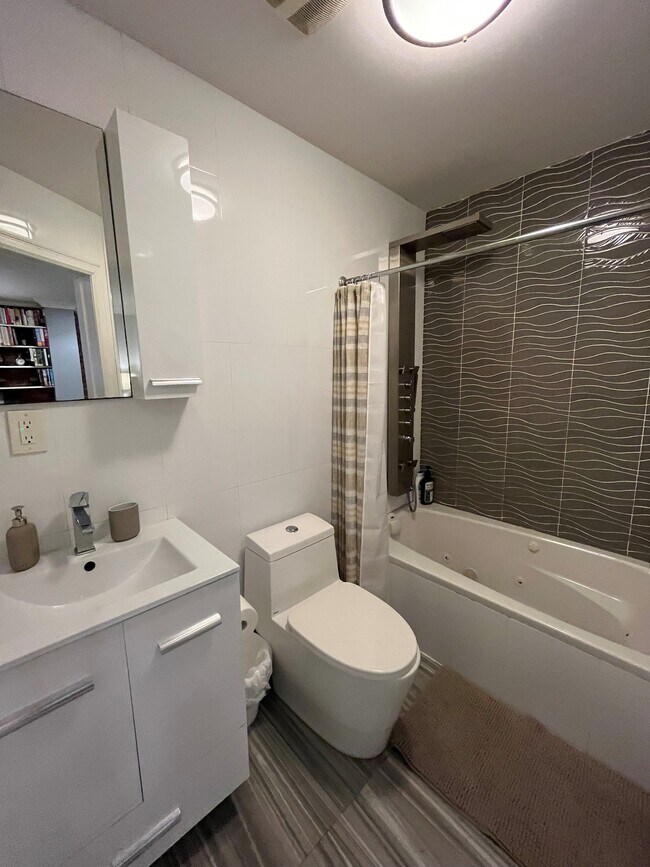Main living space full bathroom with spa shower and jetted tub - 192 Hart St