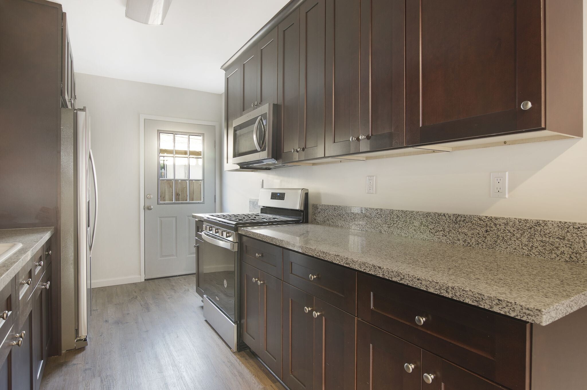 remodeled kitchen with stainless steel stove, washer/dryer and refrigerator - 4091 Rosecrans Ave