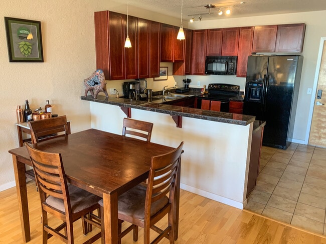 Kitchen with plenty of counter space and dining area. Kitchen equipped with under-cabinet lighting. - 3101 Blake St