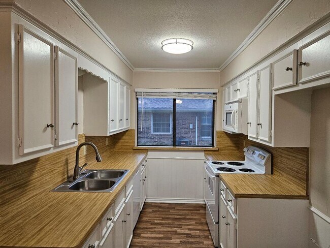 Building Photo - Three bedroom and two bathroom nicely remodeled with new flooring. Large wood fenced backyard