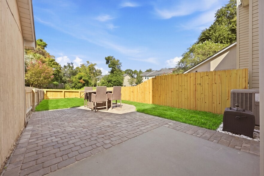 Private fenced backyard with a spacious paver patio for outdoor living. - 3622 Caroline Vale Blvd