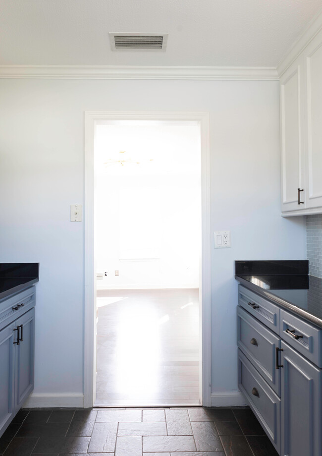 Looking through kitchen doorway into living room. Hardwood and tile floors throughout - 1217 Landon Ave