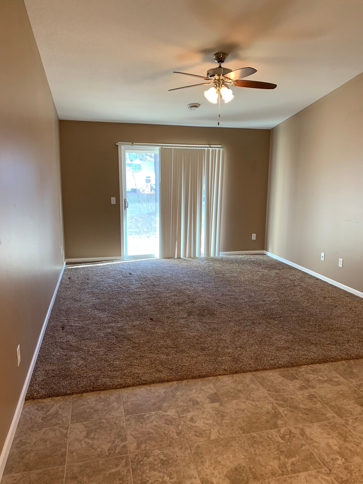 Open-concept living room opens to patio area (portion of dining room in foreground) - 967 1st st se